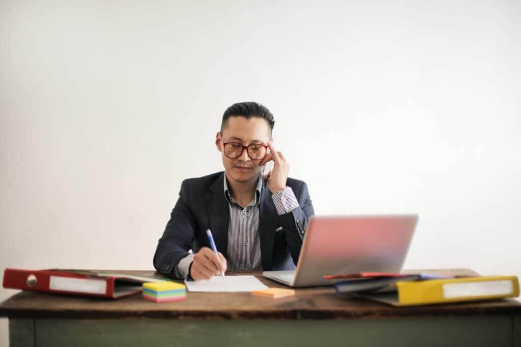 B2B sales rep dialing prospects, illustrating is cold calling still effective in 2021