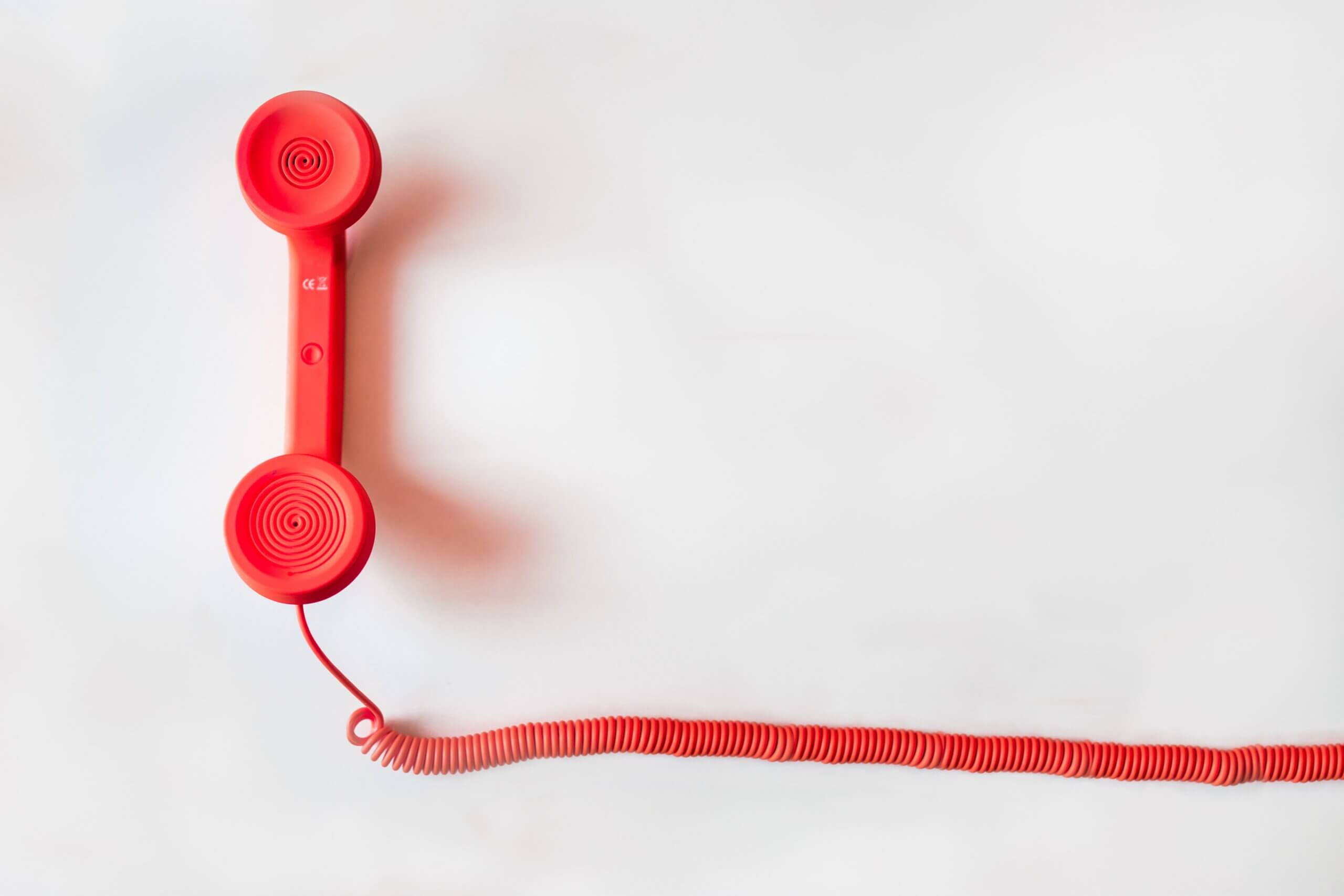 B2B sales leader reviewing cold calling conversion rate calculator with dial-to-meeting benchmarks dashboard