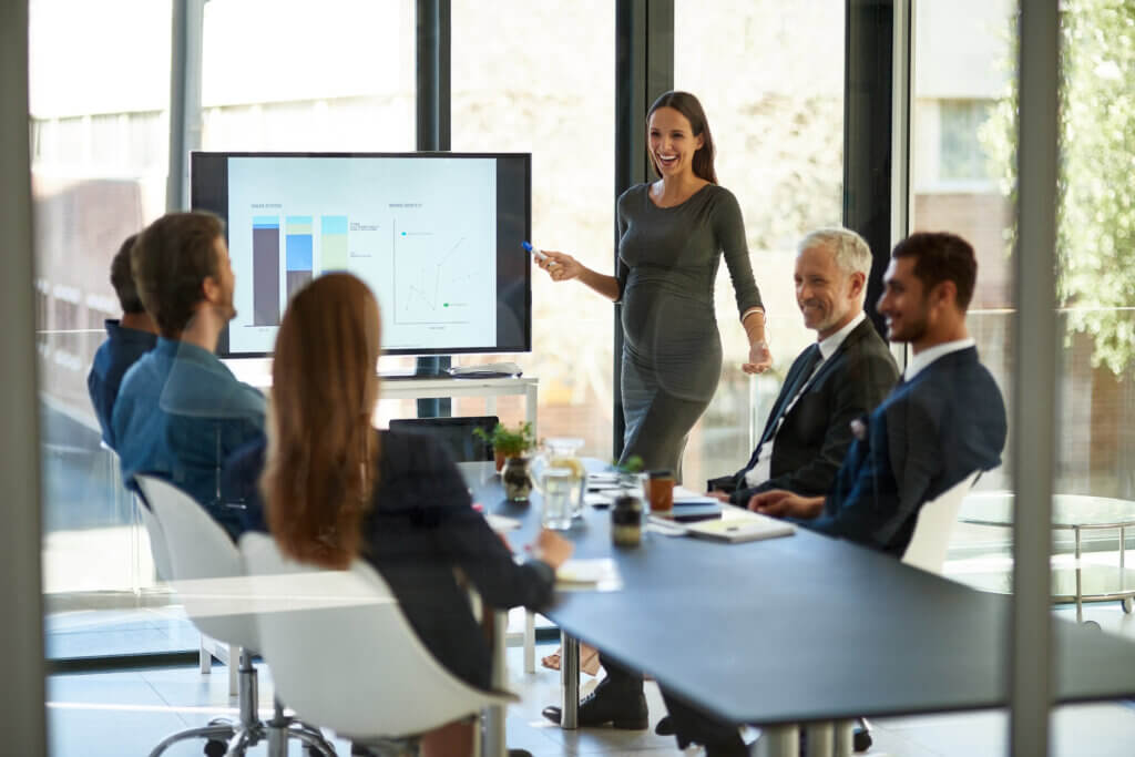 B2B sales team reviewing BDR outsourcing performance metrics and cost savings dashboard