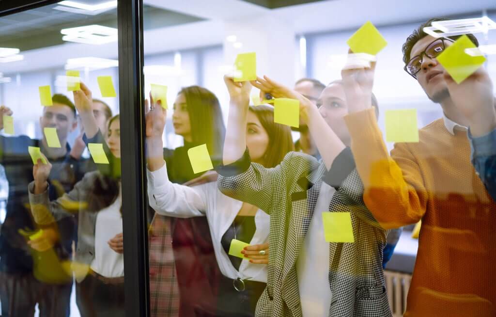 B2B sales team mapping lead generation funnels stages and outbound benchmarks on whiteboard