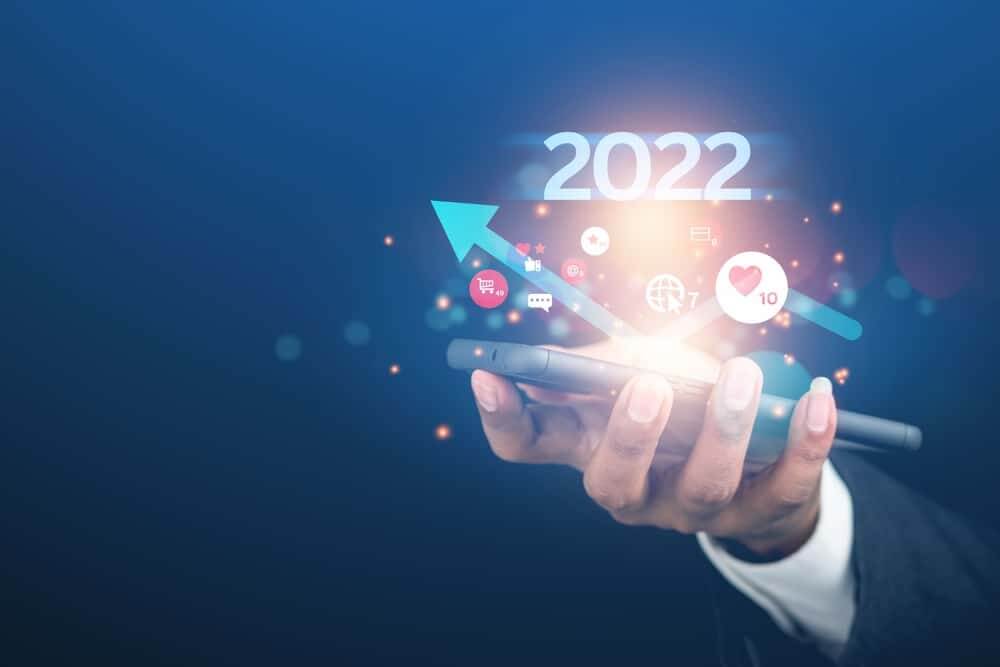 Business professionals reviewing B2B marketing trends 2022 on digital dashboard and charts