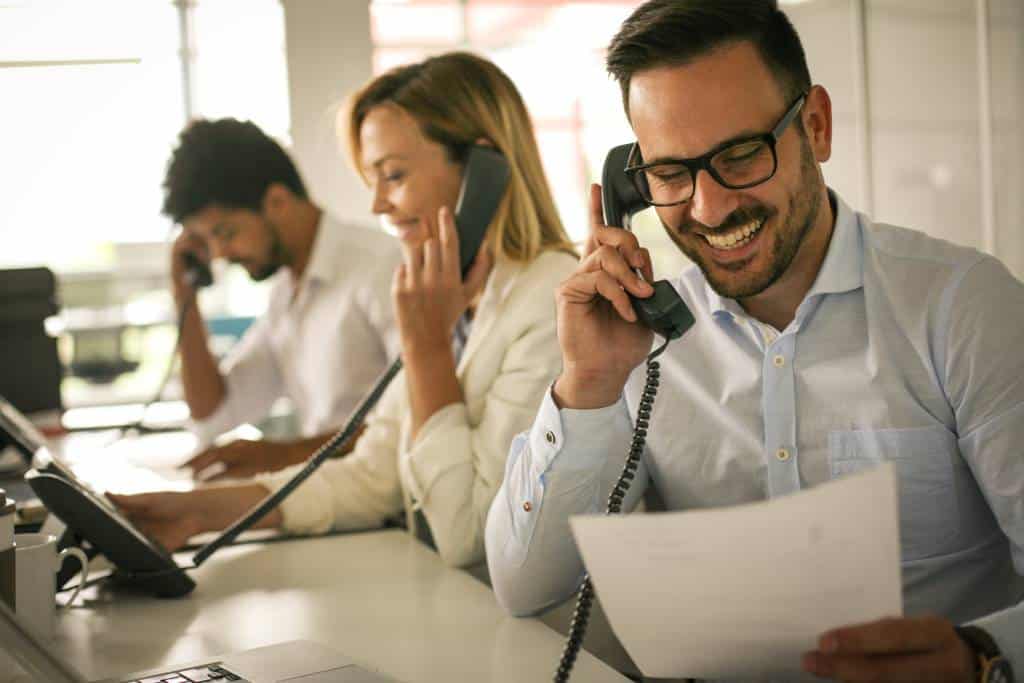 B2B salesperson on cold call reviewing sales questions to ask prospects checklist