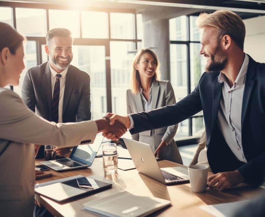 B2B sales leaders shaking hands to grow revenue through strategic B2B partnerships